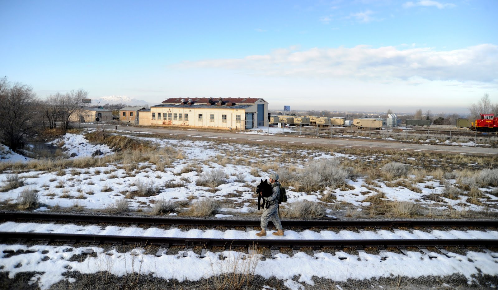 Staff Sgt. Erick Martinez, a military dog handler, carries Argo II March 4, 2011