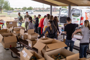 Volunteers prepare an assembly line to facilitate packing 200 boxes.