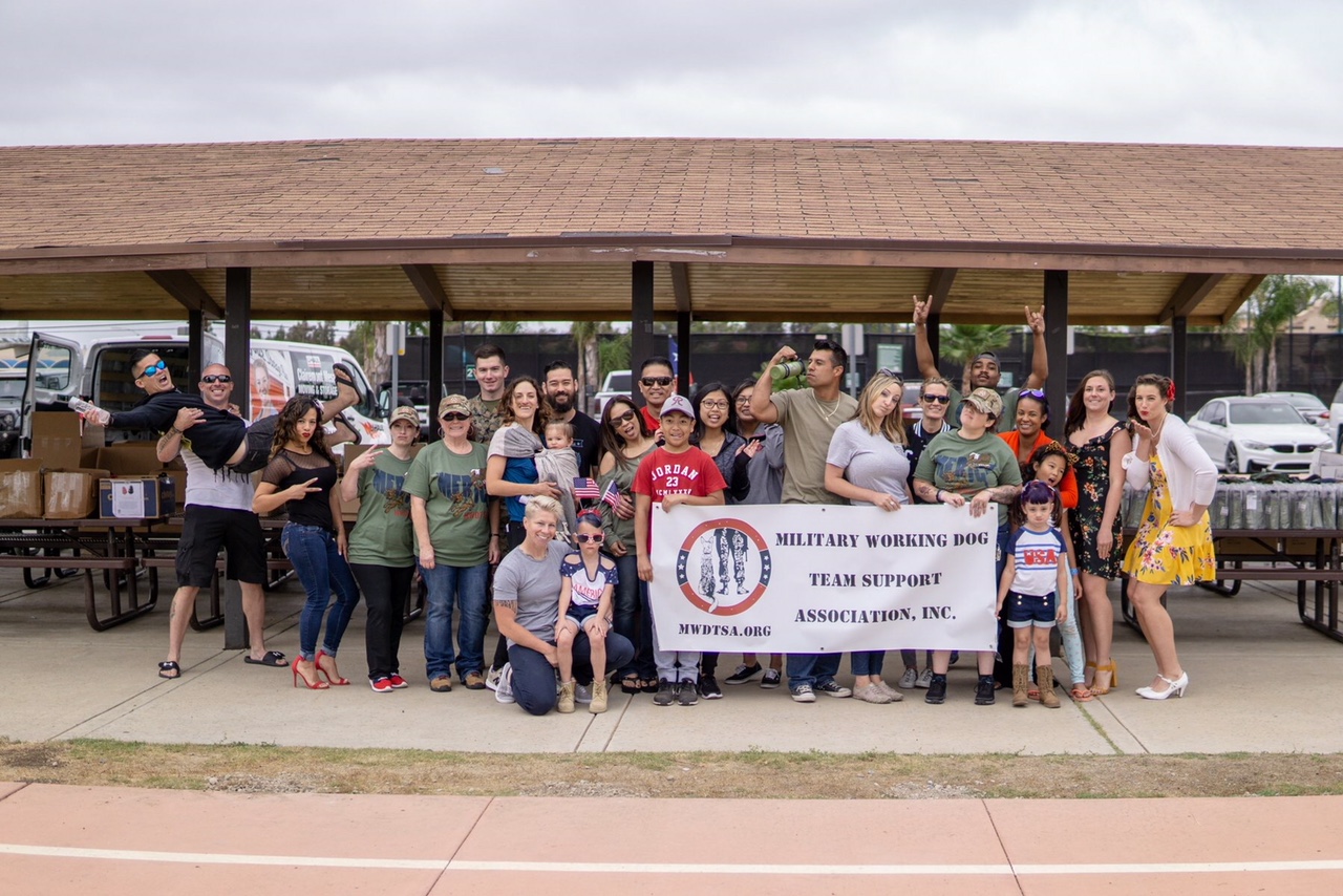 In this photo, 27 Q2-2018 packing volunteers pose with the MWDTSA banner.