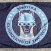 This image shows the MWDTSA Guardians of the Night flag laid out flat on a sidewalk.