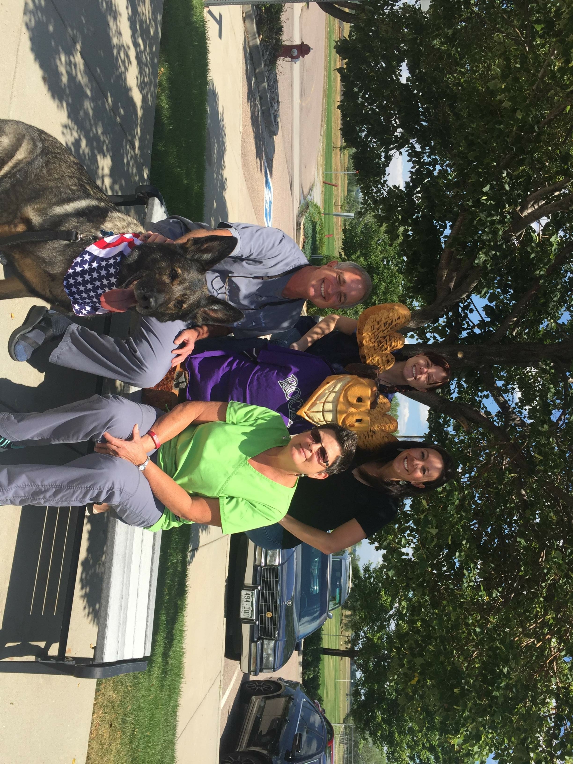 This photo shows the Align Orthodontics staff, including Dr. Colletti, along with wooden moose mascot Justin Timbertooth and guest RMWD Falco.