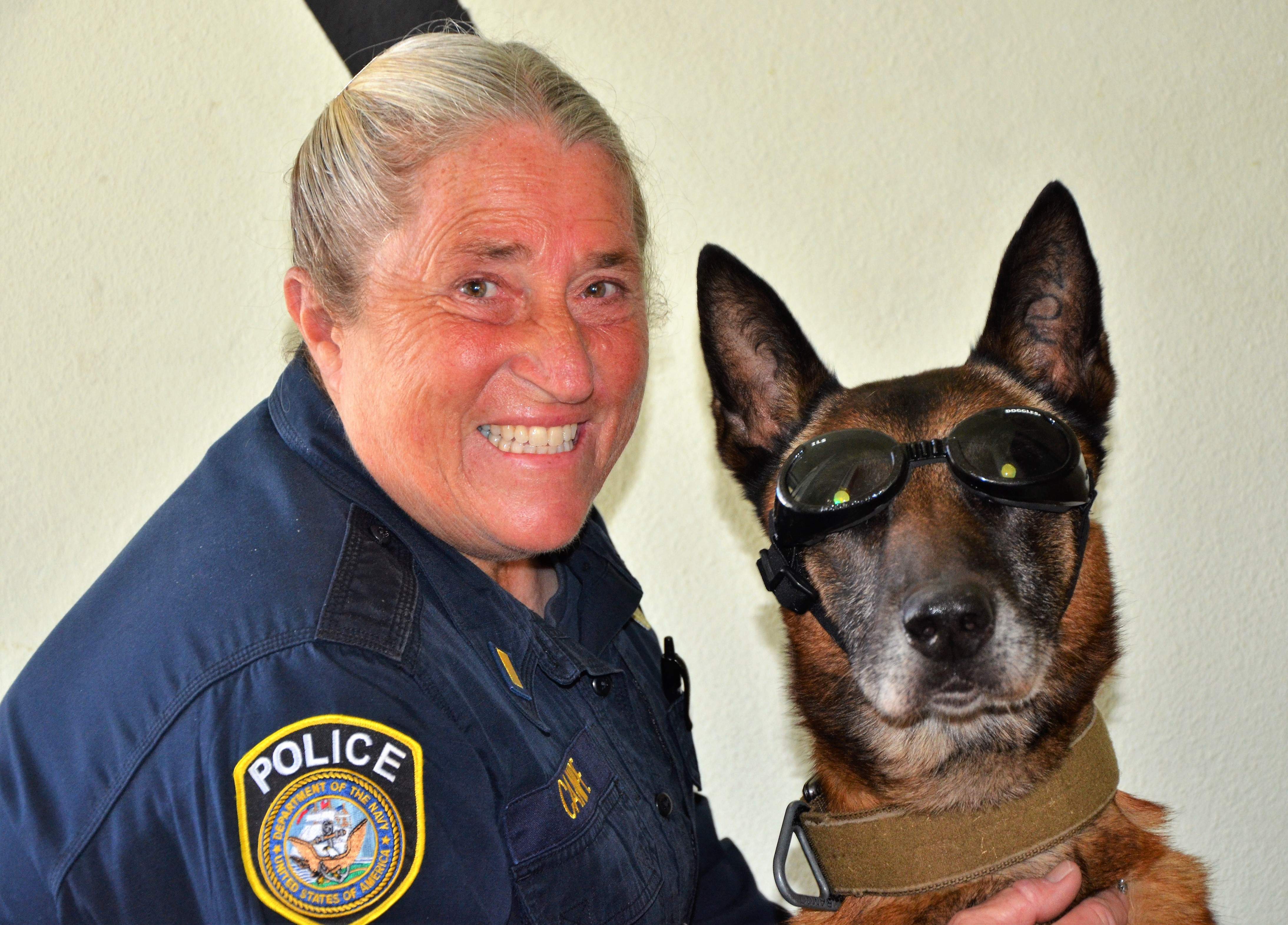 This photo shows Retired Chief Petty Officer Millie Canipe with MWD Rex.