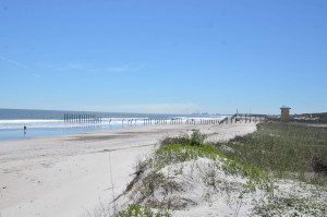 Photo shows fence separating Naval Base Mayport waterfront from civilian beach. 