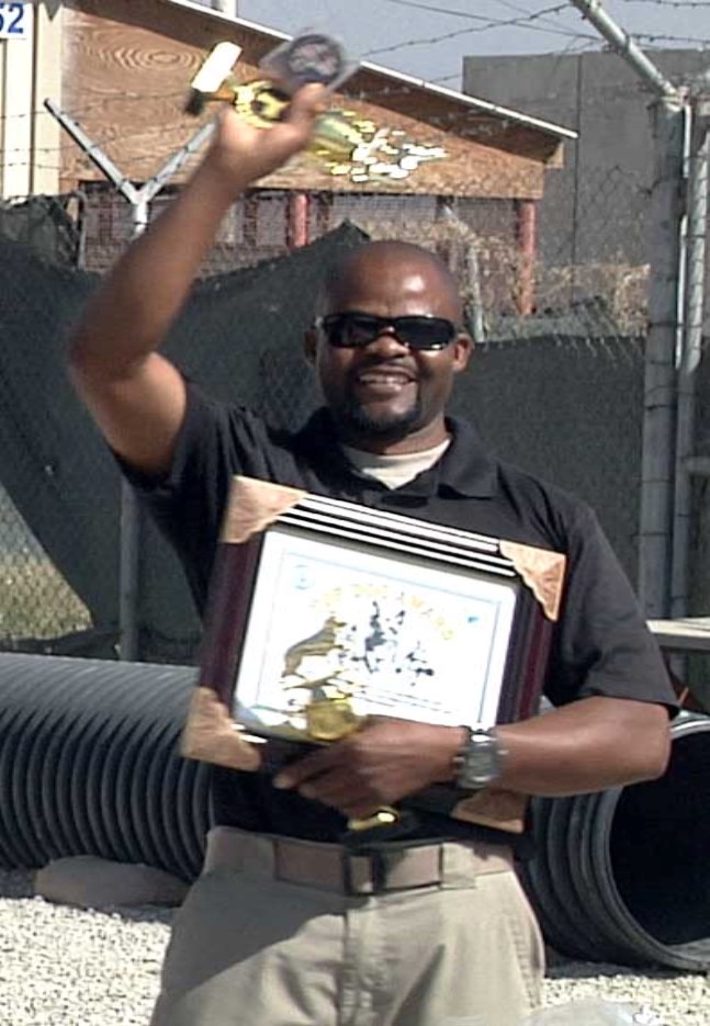 Dog handler Frank Musoli holds prizes from the K9 competition.