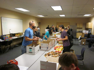 This image shows the packing team working in the style of an assembly line.