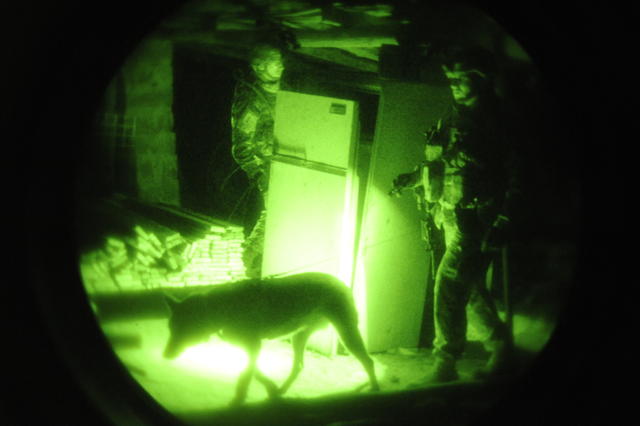 U.S. Air Force Staff Sgt. Francis from Offutt Air Force Base, Neb., and his military working dog, Z, search abandoned lots in Bacharia, Iraq, Dec. 17, 2008, as part of a joint search of the community conducted by 4th Squadron, 5th Cavalry Regiment, 2nd Brigade, 1st Infantry Division. (U.S. Air Force photo by Senior Airman Daniel Owen/Released)